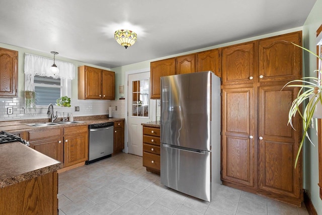 931 Carney Blvd, Marinette, WI 54143 - kitchen with appliances with stainless steel finishes, brown cabinetry, healthy amount of natural light, and decorative backsplash