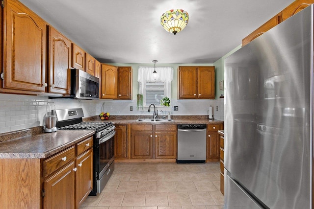 931 Carney Blvd, Marinette, WI 54143 - kitchen featuring stainless steel appliances, brown cabinets, decorative backsplash, and dark countertops
