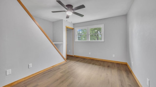 N3923 Sunny Slope Ave, Cascade, WI 53011 - unfurnished room featuring wood finished floors, ceiling fan, and stairs