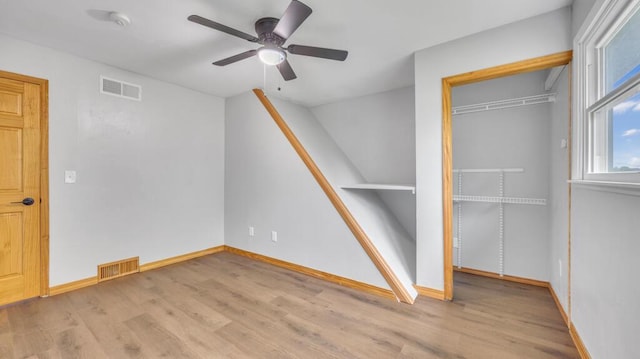 N3923 Sunny Slope Ave, Cascade, WI 53011 - unfurnished bedroom with wood finished floors, a closet, a ceiling fan, and lofted ceiling