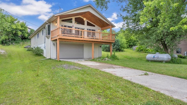 N3923 Sunny Slope Ave, Cascade, WI 53011 - view of front of home featuring concrete driveway, a front yard, a garage, and a wooden deck