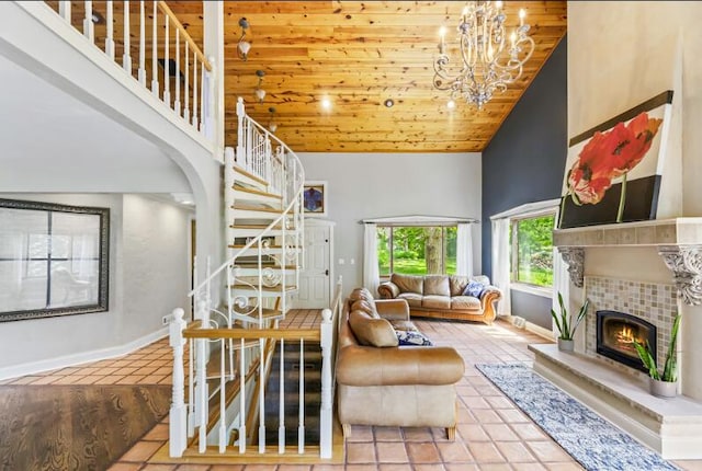205 Kummrow Ct, Wales, WI 53183 - tiled living area with high vaulted ceiling, stairs, a fireplace, a chandelier, and wooden ceiling