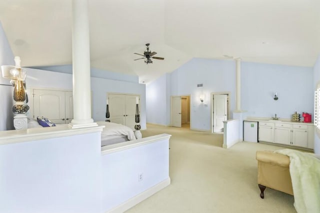 205 Kummrow Ct, Wales, WI 53183 - living room with decorative columns, high vaulted ceiling, ceiling fan, and light carpet