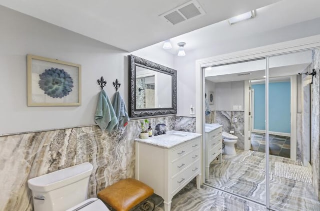 205 Kummrow Ct, Wales, WI 53183 - bathroom featuring tile walls, vanity, and wainscoting
