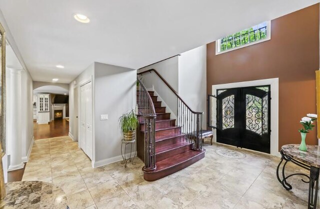 205 Kummrow Ct, Wales, WI 53183 - foyer featuring arched walkways, stairs, and french doors