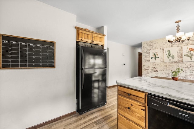 222531 Azalea Rd, Wausau, WI 54401 - kitchen with black appliances, light wood-style floors, a chandelier, light stone counters, and decorative light fixtures