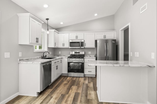 6611 Conner Davis Dr, Wausau, WI 54401 - kitchen featuring stainless steel appliances, white cabinets, lofted ceiling, light stone counters, and dark wood-style flooring
