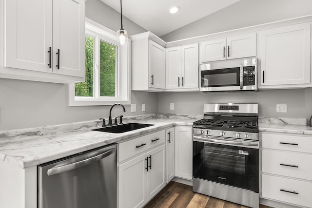 6611 Conner Davis Dr, Wausau, WI 54401 - kitchen featuring stainless steel appliances, lofted ceiling, white cabinetry, light stone counters, and pendant lighting