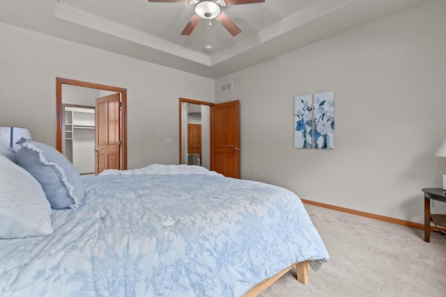2506 Waterford Ct, Neenah, WI 54956 - carpeted bedroom featuring a raised ceiling, a spacious closet, a ceiling fan, and a closet