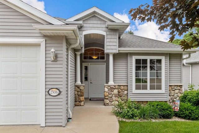 2506 Waterford Ct, Neenah, WI 54956 - view of exterior entry with an attached garage, stone siding, and roof with shingles