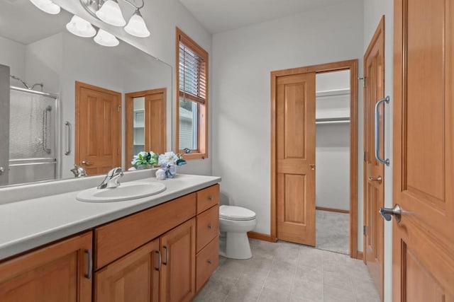 2506 Waterford Ct, Neenah, WI 54956 - bathroom with vanity, a shower stall, a closet, and tile patterned floors
