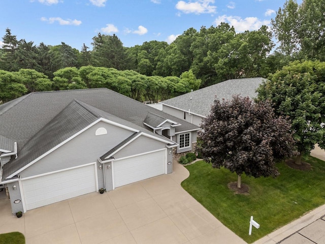 2506 Waterford Ct, Neenah, WI 54956 - view of front of house with an attached garage, driveway, roof with shingles, and a front lawn
