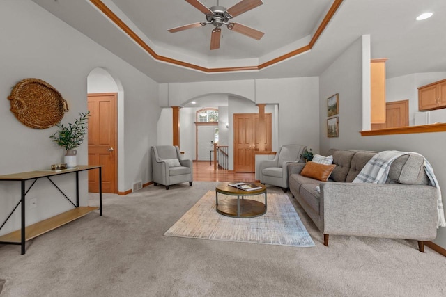 2506 Waterford Ct, Neenah, WI 54956 - carpeted living room with arched walkways, a raised ceiling, a ceiling fan, and recessed lighting