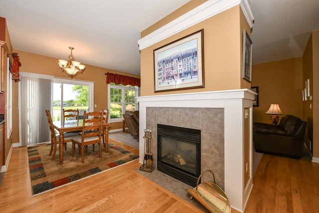 953 Eagleton Dr Unit 46-05, Lake Geneva, WI 53147 - dining area with wood finished floors, a chandelier, and a tile fireplace