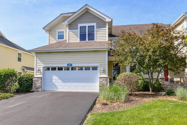 953 Eagleton Dr Unit 46-05, Lake Geneva, WI 53147 - view of front facade with a garage, asphalt driveway, a shingled roof, and stone siding