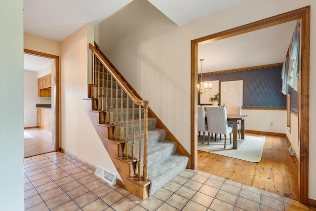 10800 N Norway Dr, Mequon, WI 53092 - staircase with a chandelier and wood finished floors