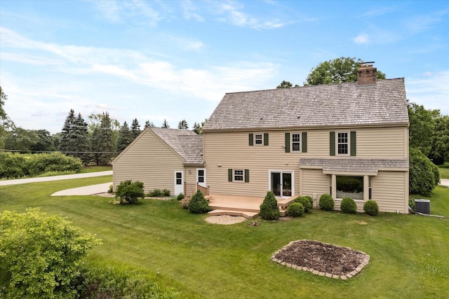 10800 N Norway Dr, Mequon, WI 53092 - back of house featuring a chimney and a lawn