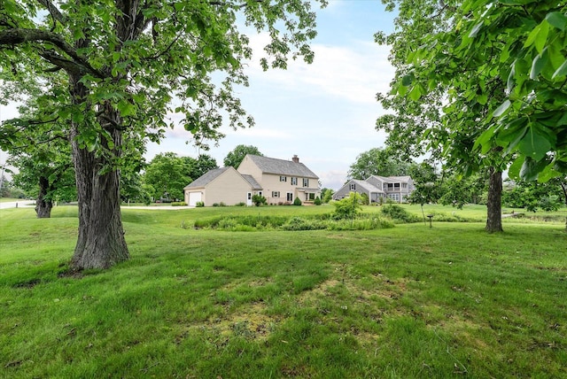 10800 N Norway Dr, Mequon, WI 53092 - view of green lawn featuring a garage