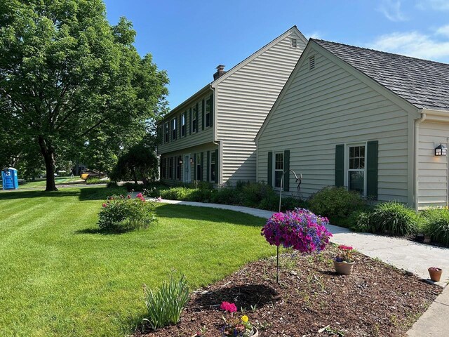 10800 N Norway Dr, Mequon, WI 53092 - view of side of property with a yard and a chimney