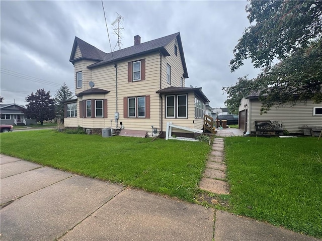 397 W Main St, Mondovi, WI 54755 - back of house with a lawn, a chimney, and a shingled roof