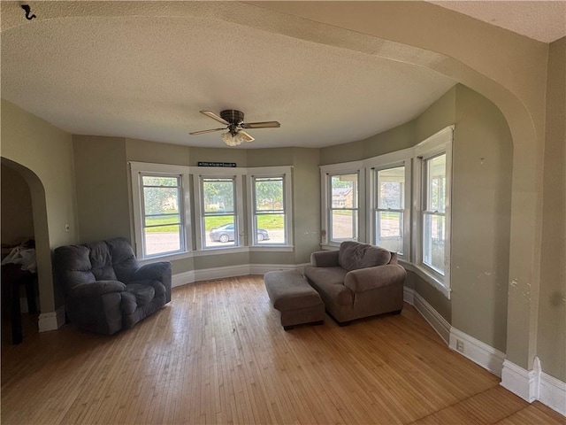 397 W Main St, Mondovi, WI 54755 - sitting room with arched walkways, a ceiling fan, plenty of natural light, light wood-style floors, and a textured ceiling