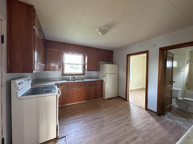 N133 Bartell St, Stephenson, MI 49887 - kitchen with white appliances, light wood-style flooring, light countertops, and brown cabinets
