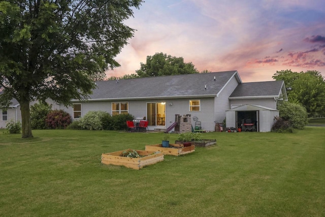 W5355 Linden Hill Dr, Appleton, WI 54915 - back of house at dusk featuring a yard, a vegetable garden, and a shed