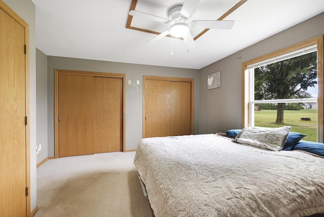 W5355 Linden Hill Dr, Appleton, WI 54915 - bedroom featuring multiple closets, light carpet, and a ceiling fan