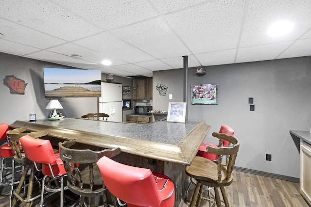W5355 Linden Hill Dr, Appleton, WI 54915 - indoor dry bar featuring freestanding refrigerator, black microwave, wood finished floors, and a drop ceiling