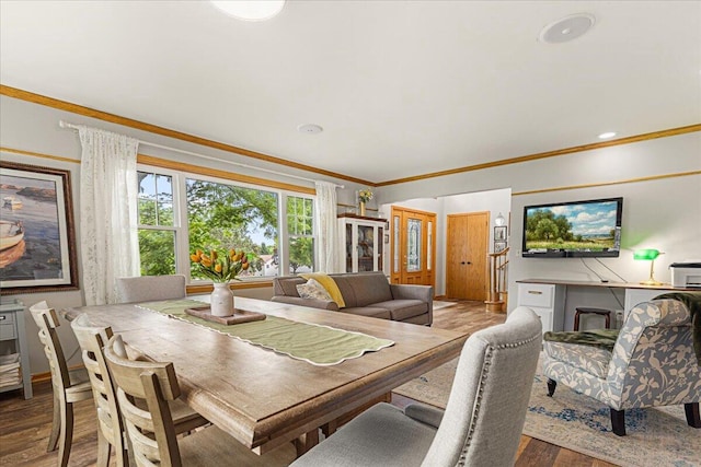 1021 Aspen Pl, West Bend, WI 53095 - dining space featuring ornamental molding and wood finished floors