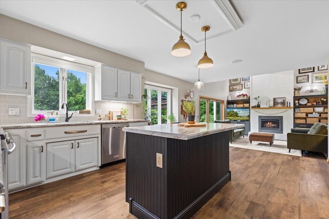 1021 Aspen Pl, West Bend, WI 53095 - kitchen featuring stainless steel dishwasher, white cabinetry, pendant lighting, and dark wood-style floors