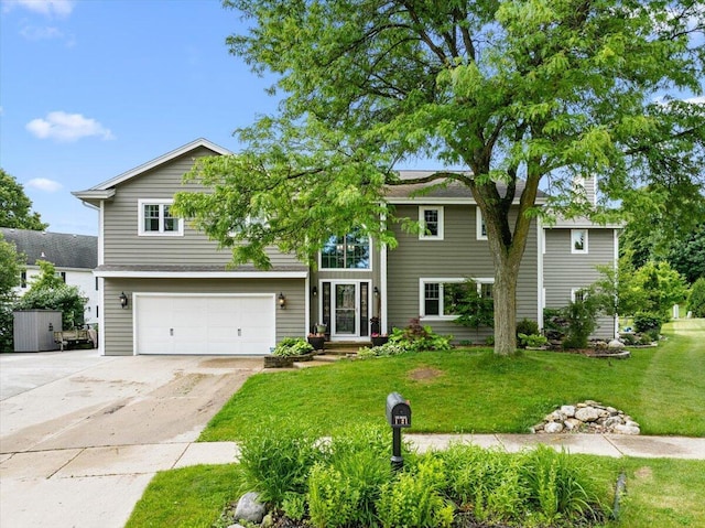 1021 Aspen Pl, West Bend, WI 53095 - view of front of home with concrete driveway, an attached garage, and a front lawn