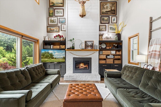 1021 Aspen Pl, West Bend, WI 53095 - living room with plenty of natural light, a fireplace, and wood finished floors