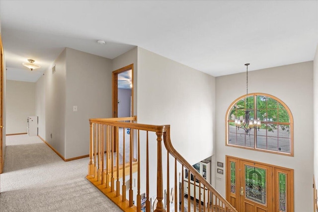 1021 Aspen Pl, West Bend, WI 53095 - corridor with an upstairs landing, a chandelier, and carpet flooring