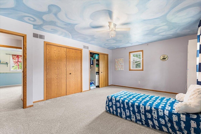 1021 Aspen Pl, West Bend, WI 53095 - carpeted bedroom with multiple windows, ceiling fan, and multiple closets