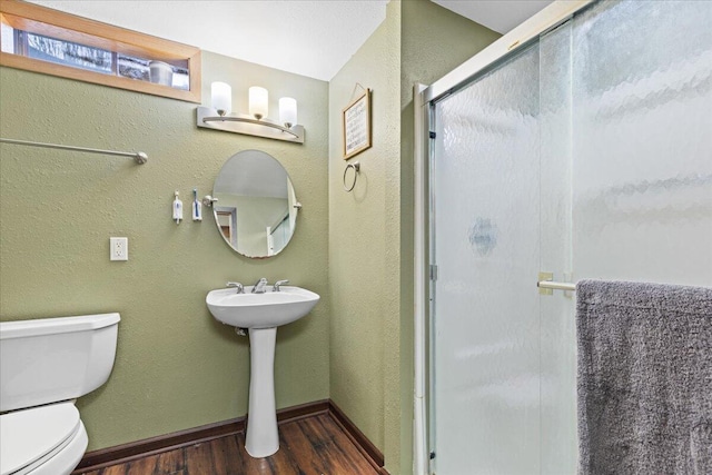 1021 Aspen Pl, West Bend, WI 53095 - full bathroom featuring wood finished floors and a shower stall