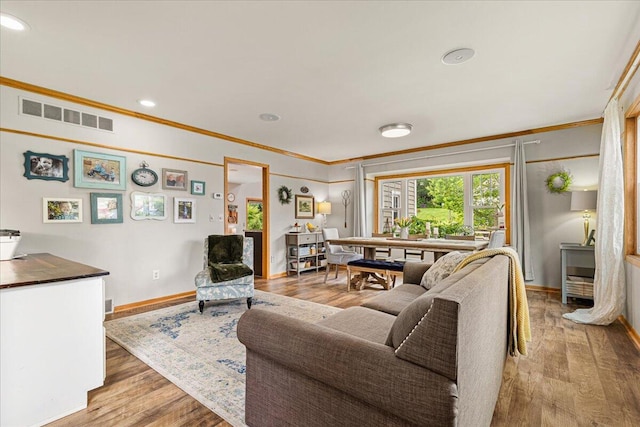 1021 Aspen Pl, West Bend, WI 53095 - living room with crown molding, light wood finished floors, and recessed lighting
