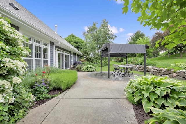 742 Charolais Dr, Slinger, WI 53086 - view of property's community featuring a patio, outdoor dining area, and a yard