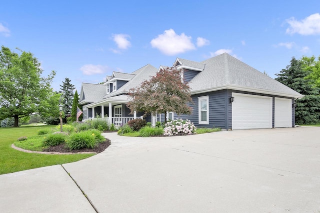 742 Charolais Dr, Slinger, WI 53086 - view of front of property featuring covered porch, a garage, driveway, and a front lawn
