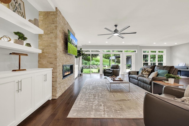 742 Charolais Dr, Slinger, WI 53086 - living room featuring ceiling fan, dark wood-style floors, a stone fireplace, and recessed lighting