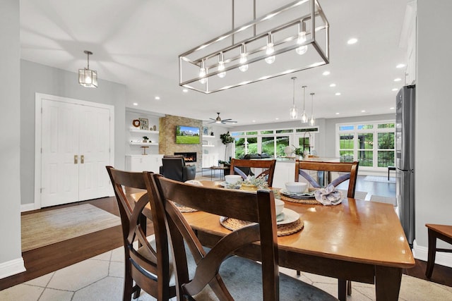 742 Charolais Dr, Slinger, WI 53086 - dining room with a fireplace, recessed lighting, built in shelves, and ceiling fan