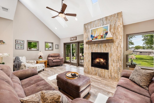 2830 Tomahawk Ct, Middleton, WI 53562 - living room with a skylight, high vaulted ceiling, a ceiling fan, and a fireplace