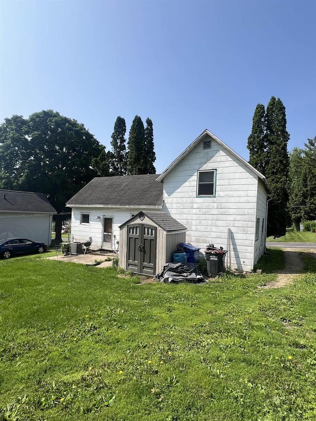 530 Wisconsin St, Columbus, WI 53925 - rear view of house with a storage shed and a lawn