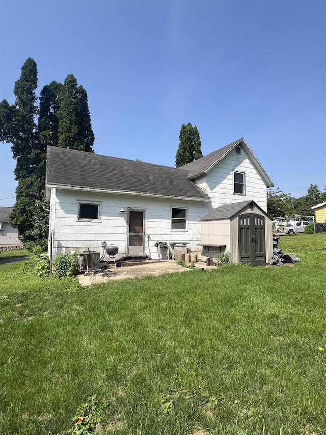 530 Wisconsin St, Columbus, WI 53925 - rear view of house with a yard, a storage unit, and a patio area