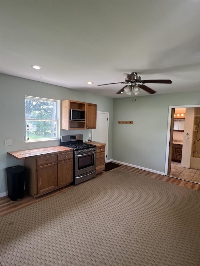 530 Wisconsin St, Columbus, WI 53925 - kitchen featuring stainless steel gas stove, a ceiling fan, open shelves, recessed lighting, and light countertops