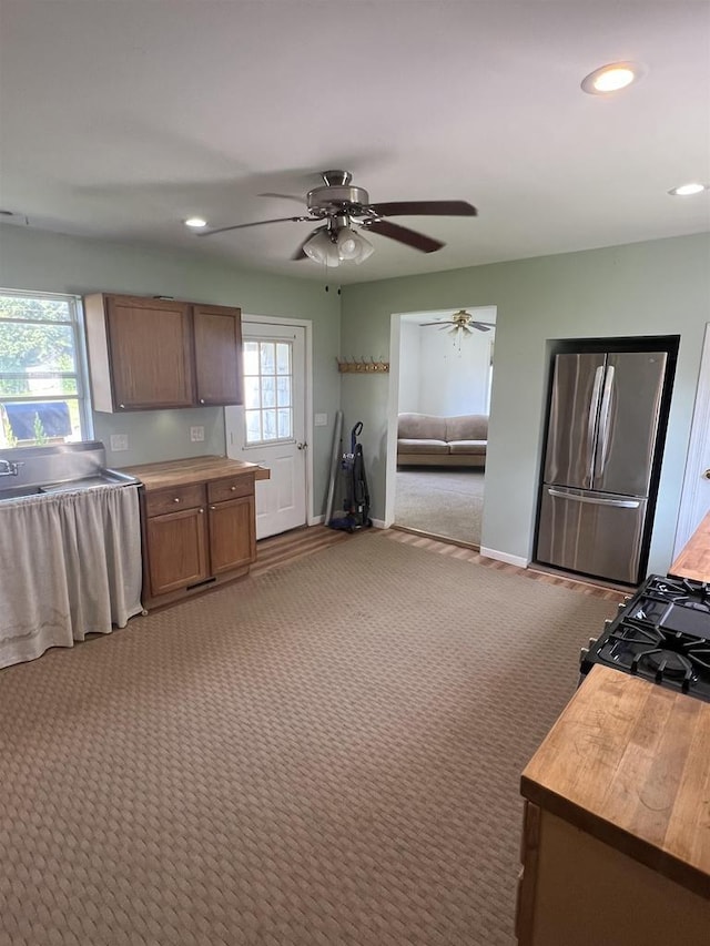 530 Wisconsin St, Columbus, WI 53925 - kitchen featuring freestanding refrigerator, wood counters, light colored carpet, ceiling fan, and recessed lighting