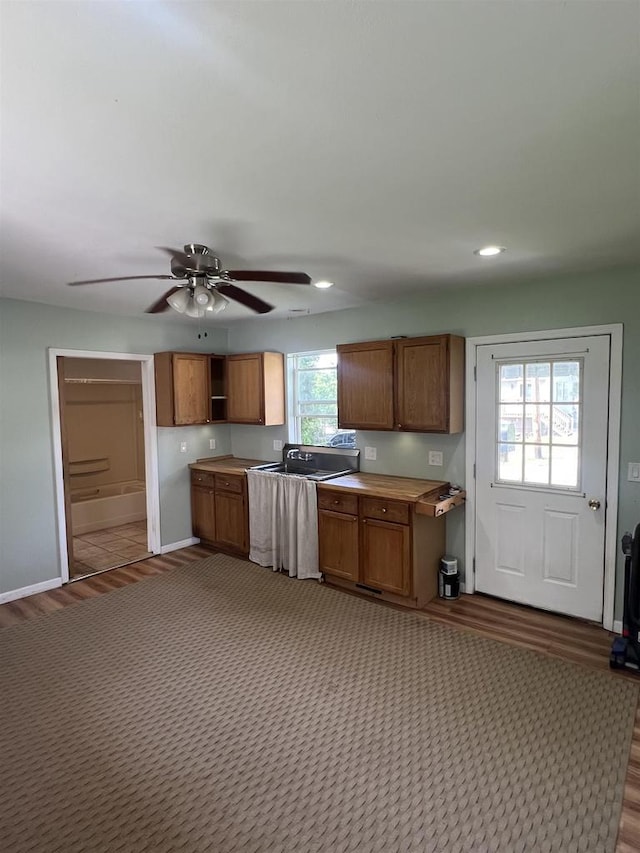 530 Wisconsin St, Columbus, WI 53925 - kitchen featuring brown cabinetry, open shelves, light countertops, ceiling fan, and recessed lighting