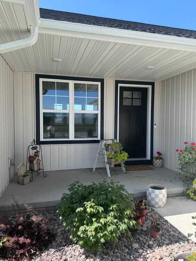 117 Cortland Ave, Casco, WI 54205 - entrance to property featuring covered porch, a shingled roof, and board and batten siding
