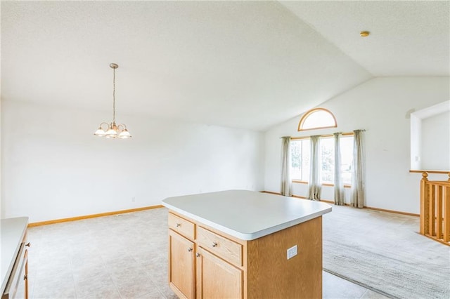 1566 Mallard Ave, Baldwin, WI 54002 - kitchen with vaulted ceiling, a kitchen island, open floor plan, a chandelier, and light countertops
