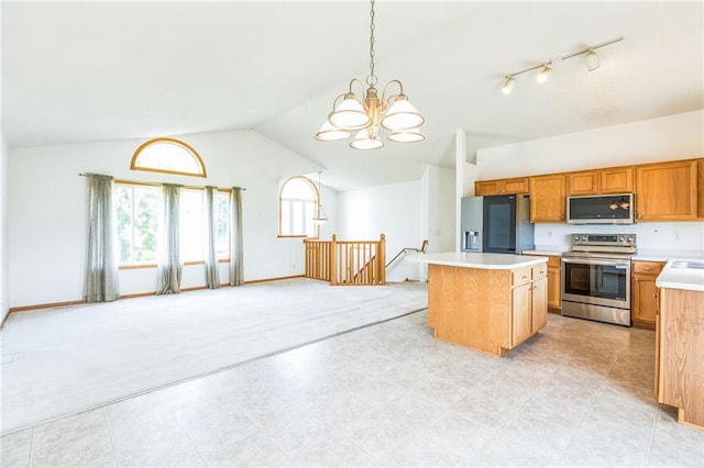 1566 Mallard Ave, Baldwin, WI 54002 - kitchen with appliances with stainless steel finishes, vaulted ceiling, a kitchen island, light countertops, and a chandelier